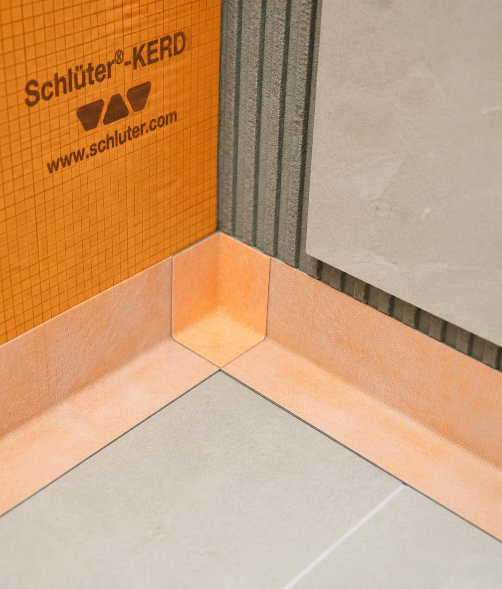 Waterproofing membrane and tile transition detail at a shower corner